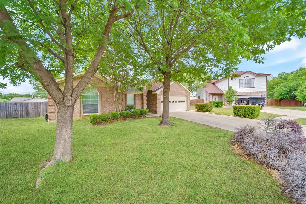 4221 Fiste Denton, TX 76207 - Photo 2 of 26 View of front of house with a garage and a front lawn