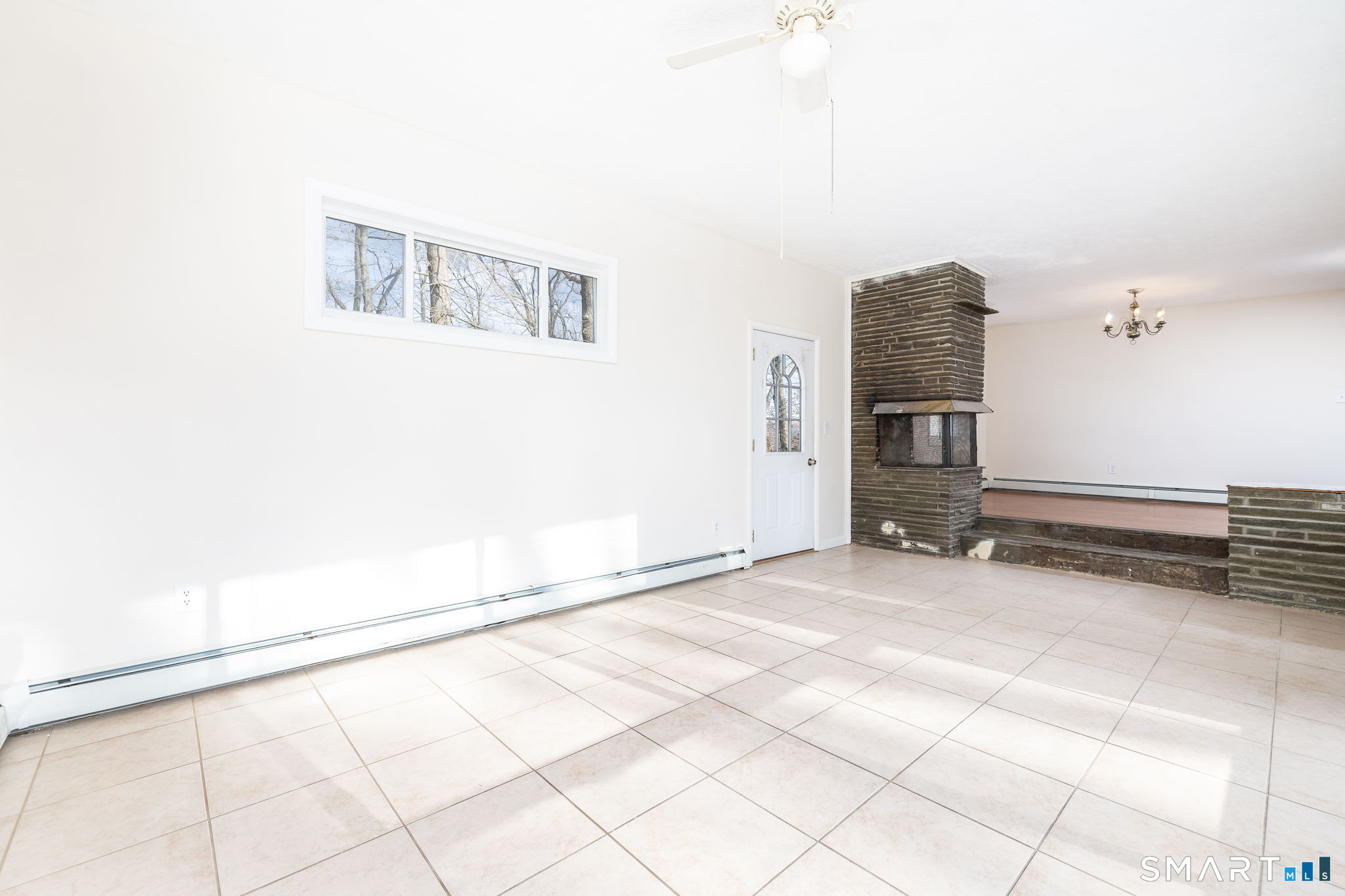 461 Pond Road Franklin, CT 06254 - Photo 4 of 35 a view of a livingroom with an empty space and a ceiling fan