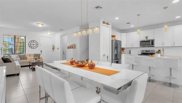 a kitchen with a sink refrigerator and cabinets