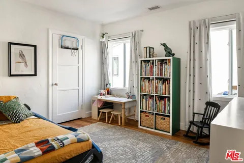 a bedroom with a bed and a book shelf