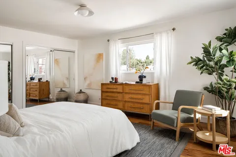 a bedroom with a bed and a couch