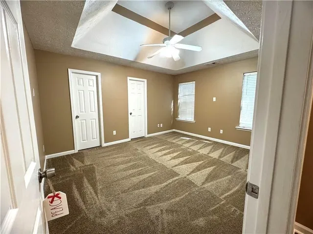 a view of a hallway with wooden floor and a livingroom