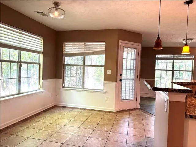 a kitchen with granite countertop a refrigerator stove and sink