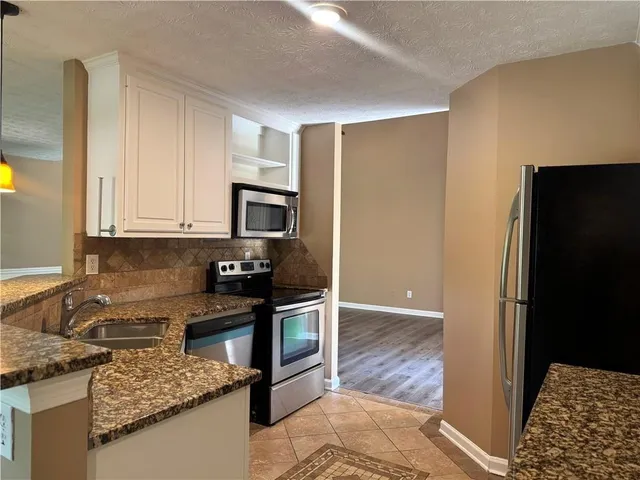 a view of a bathroom with a tub and mirror