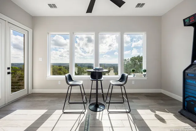 a view of a dining room with a table and chairs