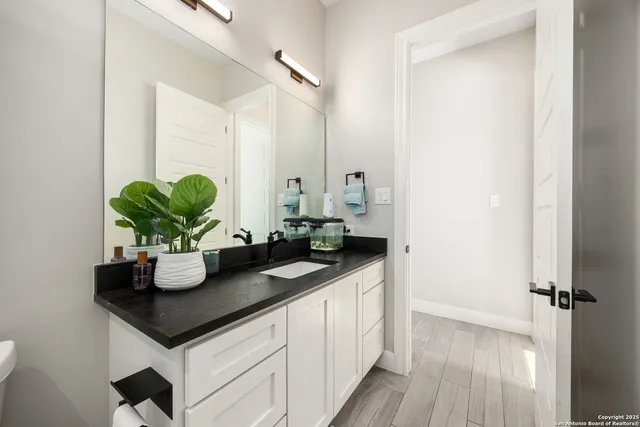 a kitchen with a sink and a mirror