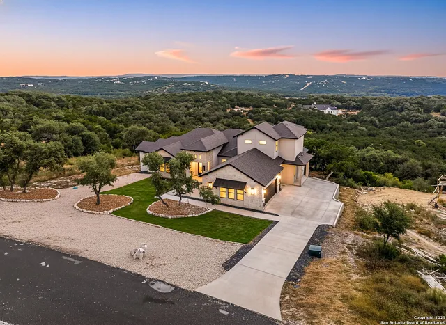 an aerial view of a house with a yard
