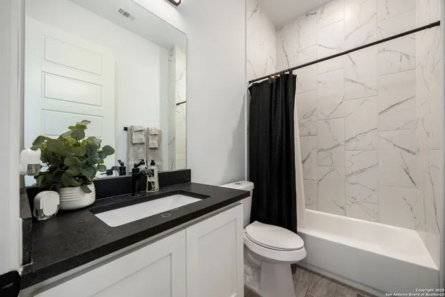 a bathroom with a sink toilet and shower