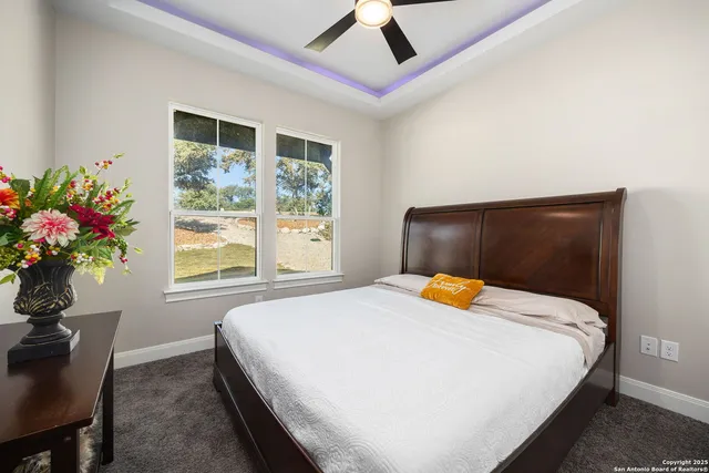 a bedroom with a bed and a potted plant