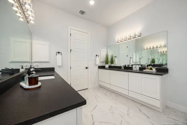 a kitchen with a sink a stove and cabinets