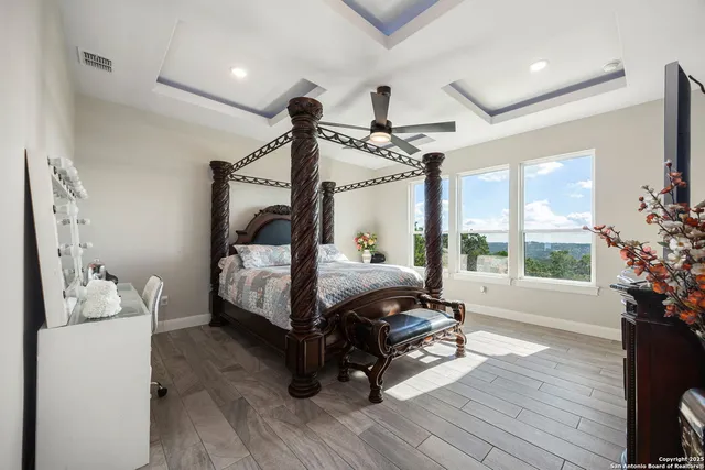 a bedroom with furniture and a large window