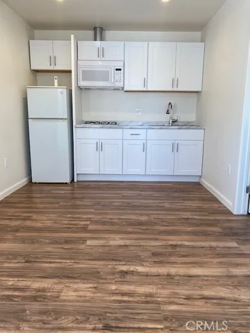 a view of kitchen with cabinets and wooden floor