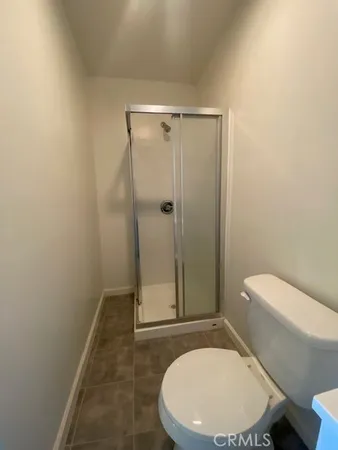 a bathroom with a toilet and a shower