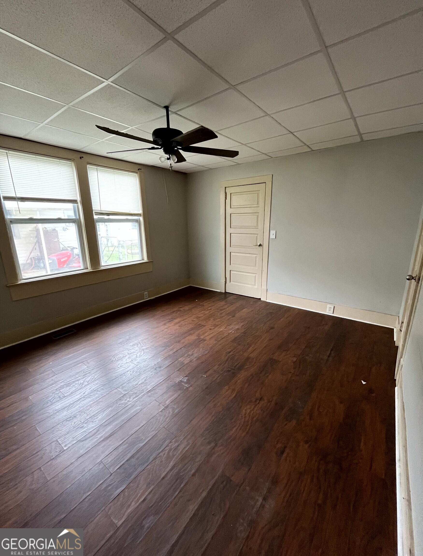 430 Knight Street Elberton, GA 30635 - Photo 9 of 15 an empty room with wooden floor fan and windows