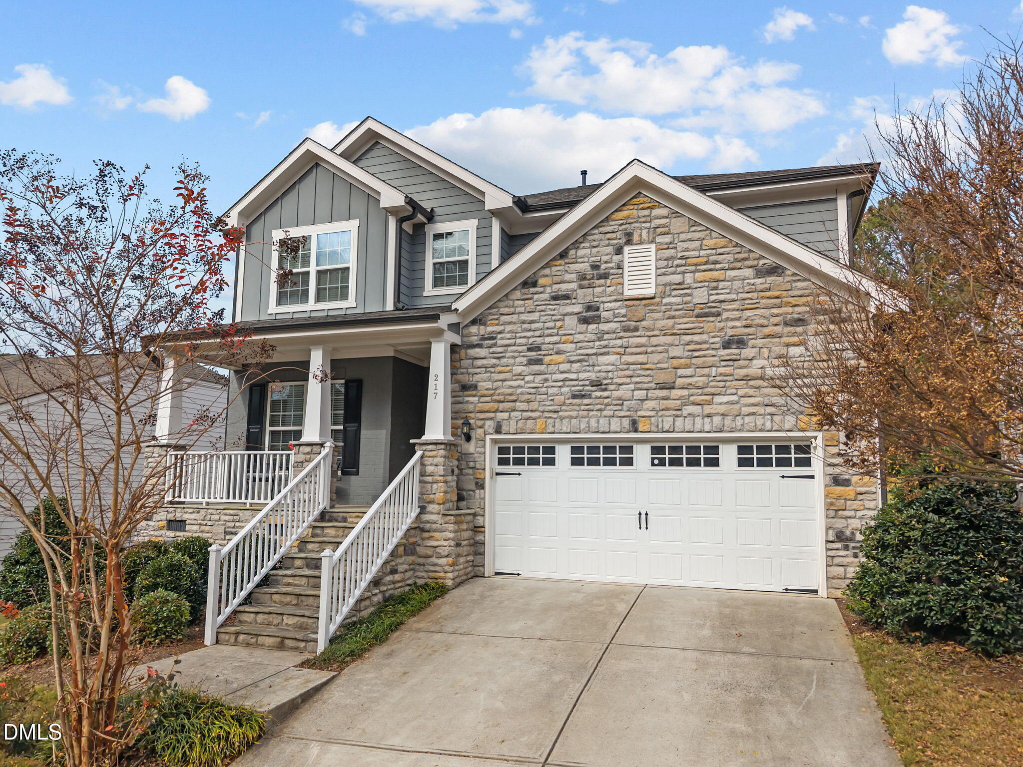 a view of a house with a yard and large tree