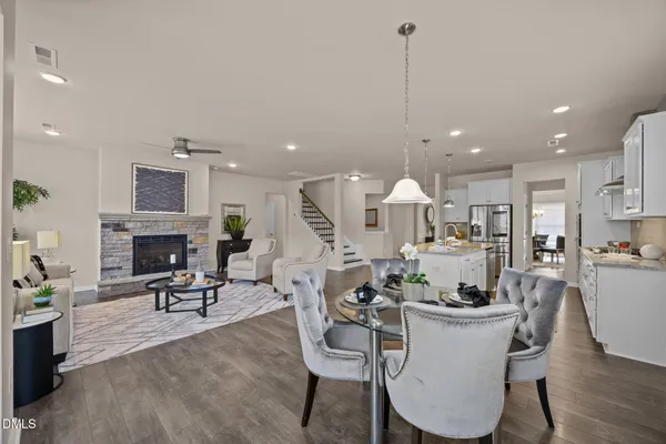 a living room with furniture a fireplace and a chandelier