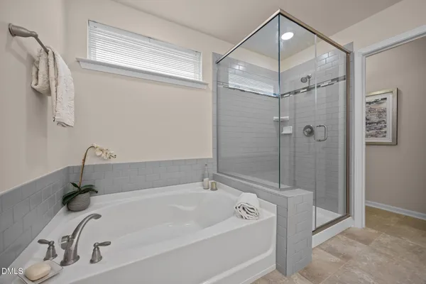 a bathroom with a tub and a shower