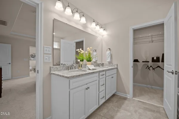a bathroom with a granite countertop sink a mirror and a shower