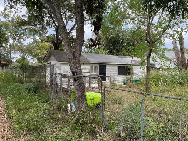 a backyard of a house with yard and outdoor seating