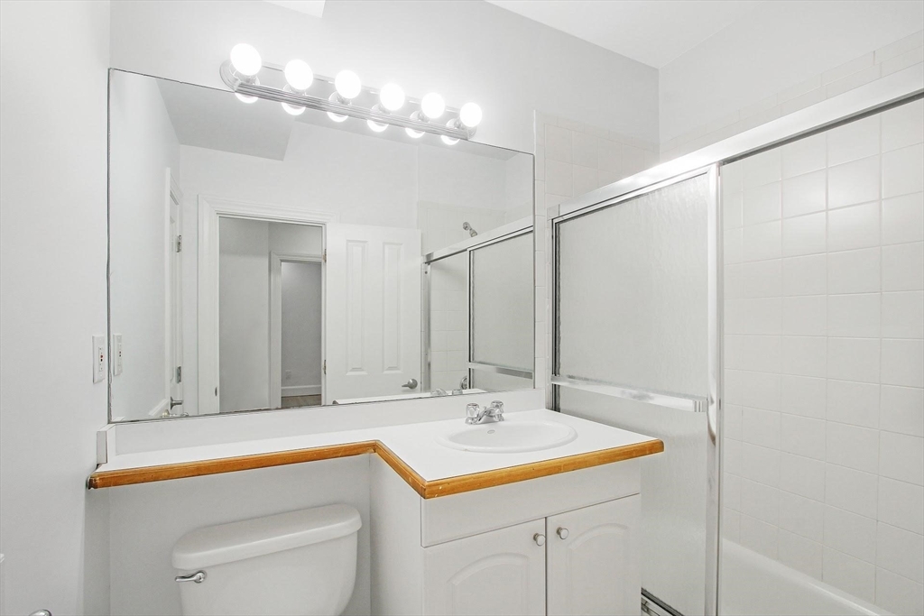 140 Boylston Street, Unit 10 Boston, MA 02116 - Photo 2 of 14 a bathroom with a sink and a mirror