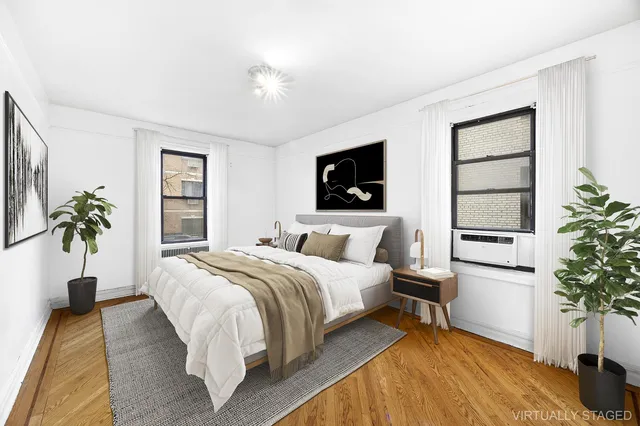 a bedroom with a bed and a potted plant