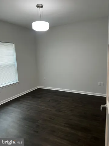 a room with wooden floor and a window