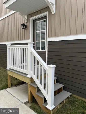 a view of a wooden house with a small yard