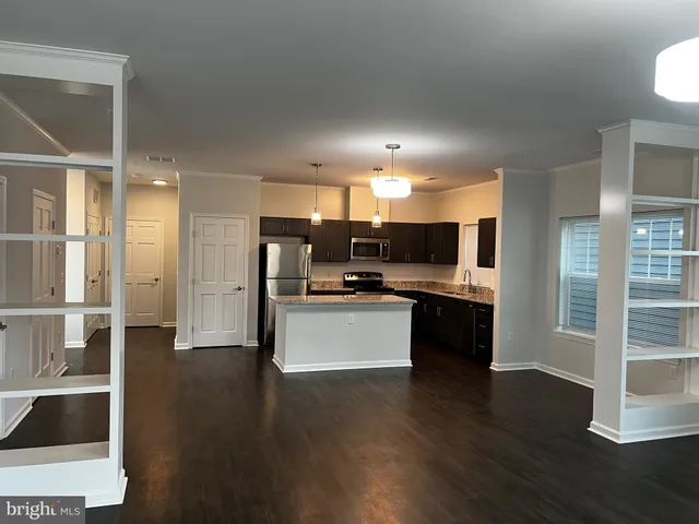 a large kitchen with a large counter top appliances and cabinets