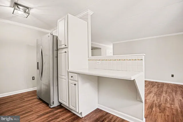a view of walk in closet with wooden floor