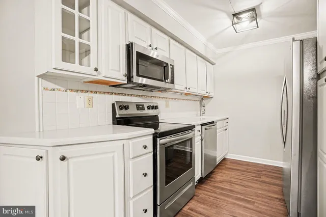 a kitchen with stainless steel appliances granite countertop a stove microwave and refrigerator