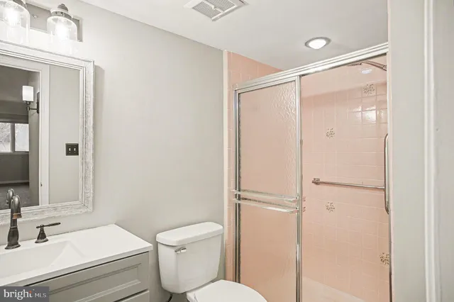 a white toilet sitting next to a bathroom sink