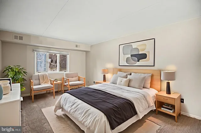 a bedroom with a bed and a couch