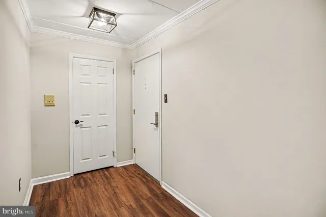 a view of empty room with wooden floor