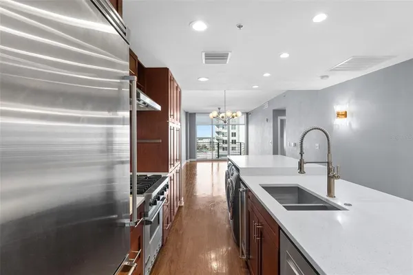 a kitchen with a sink appliances and cabinets
