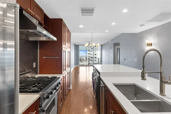 a kitchen with a sink stove and cabinets