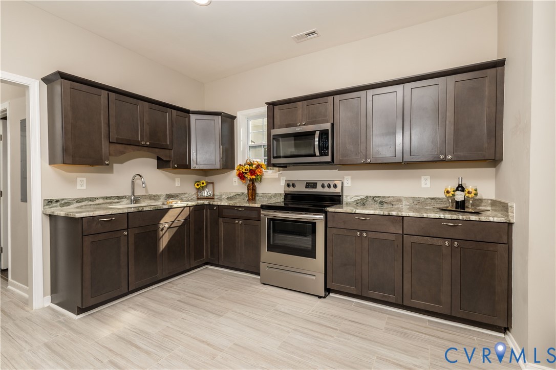 6103 Hermitage Road Henrico, VA 23228 - Photo 11 of 44 a kitchen with a sink stove and microwave