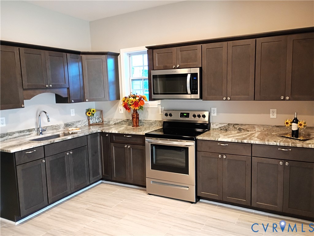 6103 Hermitage Road Henrico, VA 23228 - Photo 14 of 44 a kitchen with stainless steel appliances granite countertop a sink stove and microwave