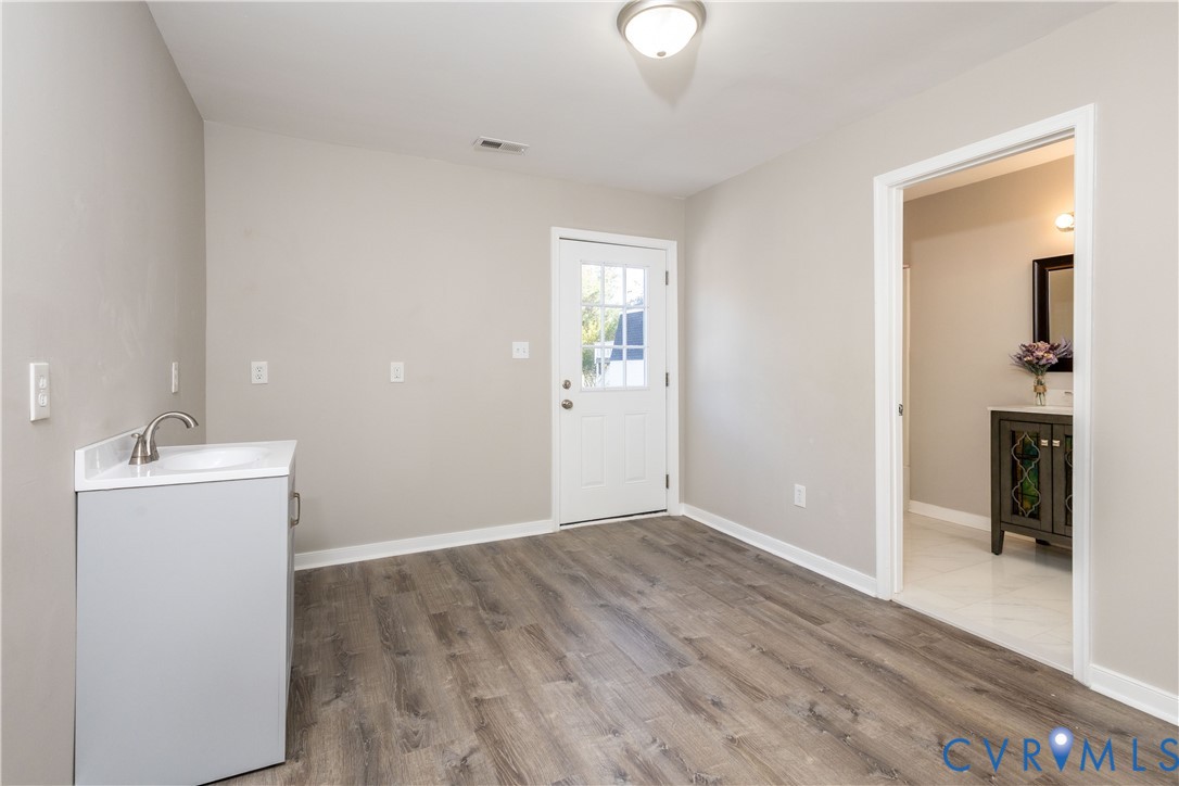 6103 Hermitage Road Henrico, VA 23228 - Photo 15 of 44 wooden floor in an empty room with a window