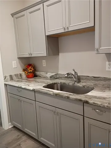 a kitchen with stainless steel appliances granite countertop white cabinets and a sink