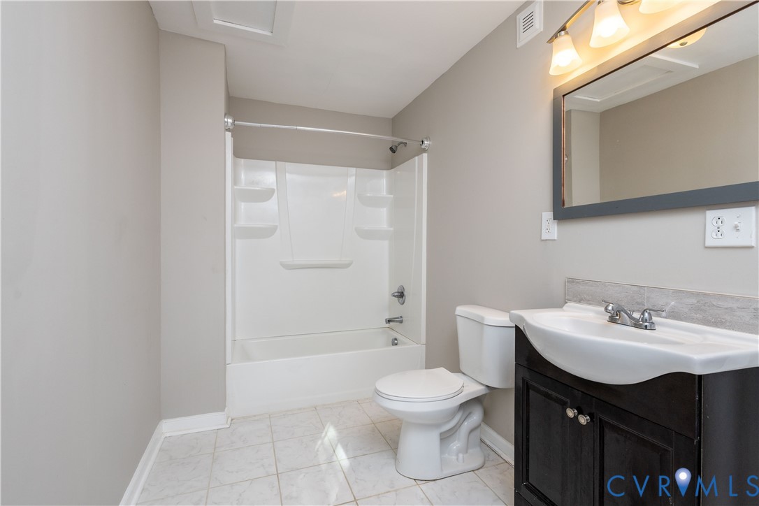 6103 Hermitage Road Henrico, VA 23228 - Photo 38 of 44 a bathroom with a sink toilet vanity and shower