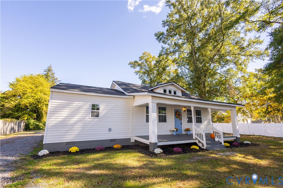 6103 Hermitage Road Henrico, VA 23228 - Photo 5 of 44 a front view of a house with a yard