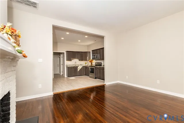 a view of a living room with kitchen furniture and a kitchen view
