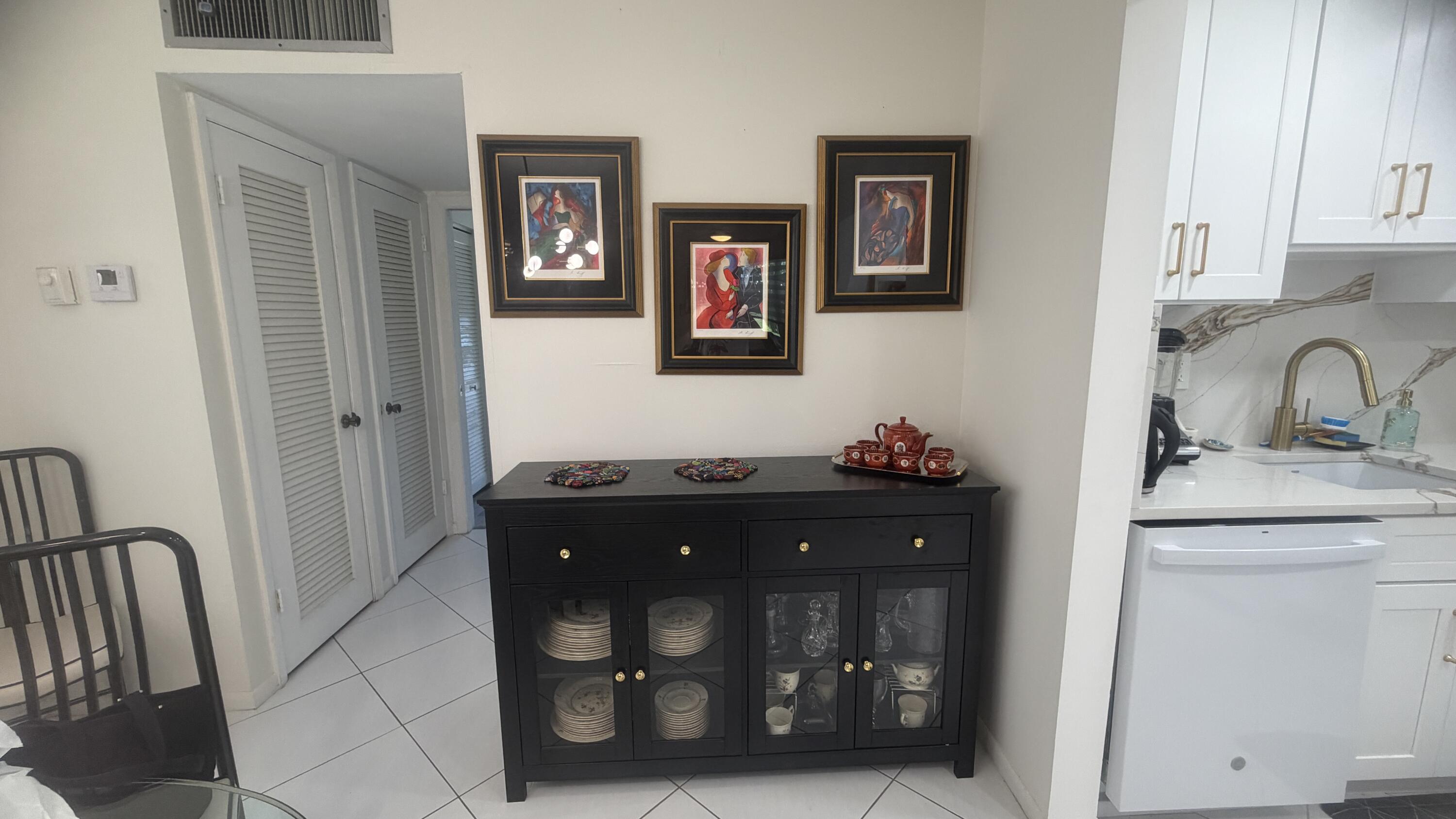 930 Normandy Trail Delray Beach, FL 33484 - Photo 4 of 34 a bathroom with a granite countertop sink vanity and mirror