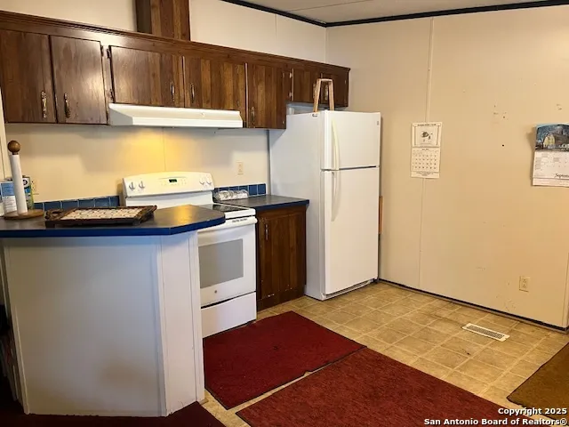 a kitchen with a sink and a refrigerator