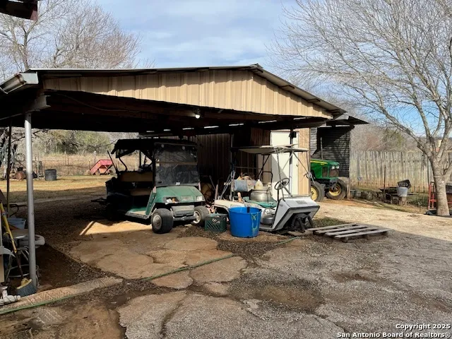 a view of a patio with table and chairs under an umbrella