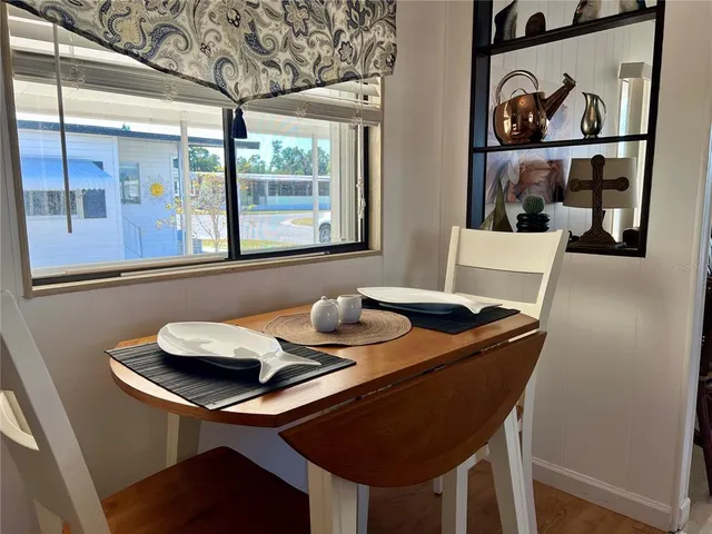 a dining room with furniture and window