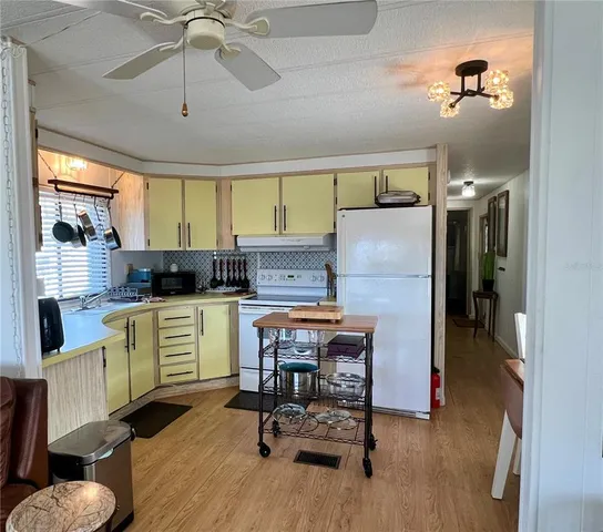 a kitchen with a table and chairs in it