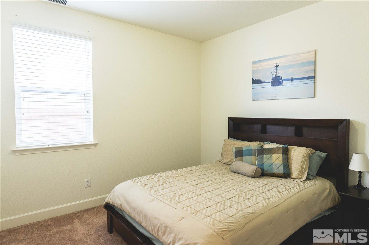 9746 Pachuca Drive Reno, NV 89521 - Photo 12 of 25 a bedroom with a bed and painting on the wall