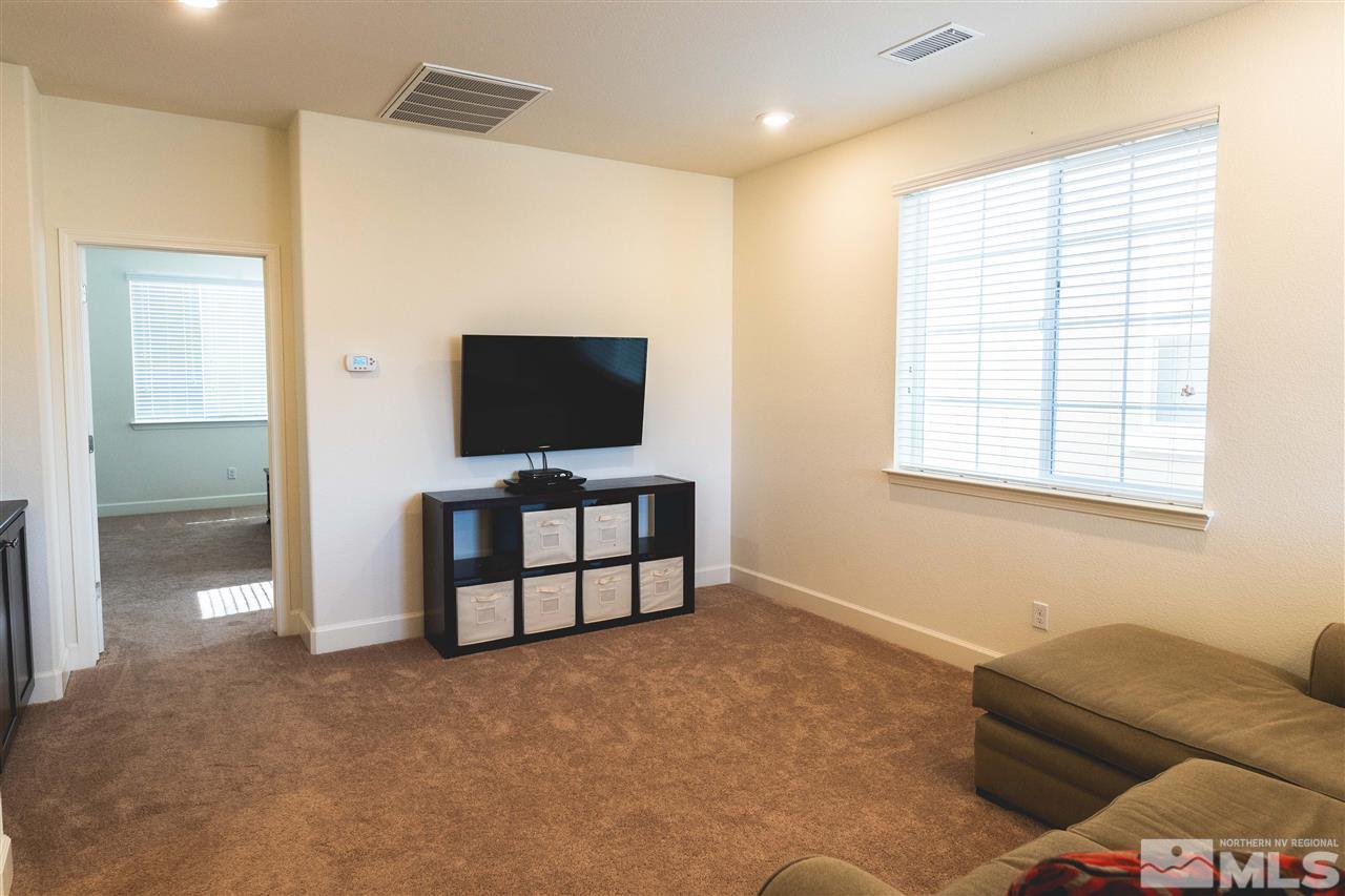 9746 Pachuca Drive Reno, NV 89521 - Photo 13 of 25 a living room with furniture and a flat screen tv