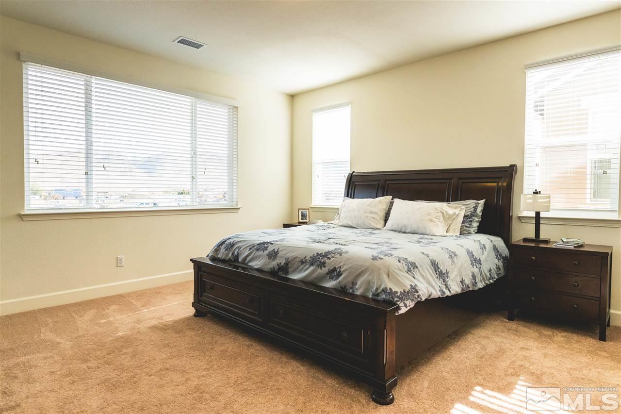 9746 Pachuca Drive Reno, NV 89521 - Photo 14 of 25 a bed sitting in a bedroom next to a window